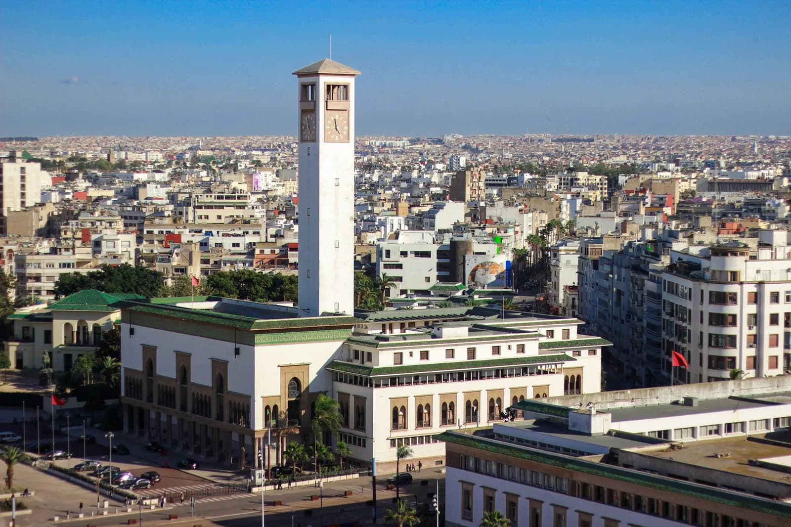 Vue aérienne du centre de Casablanca avec un immeuble à tour d'horloge au milieu de bâtiments blancs